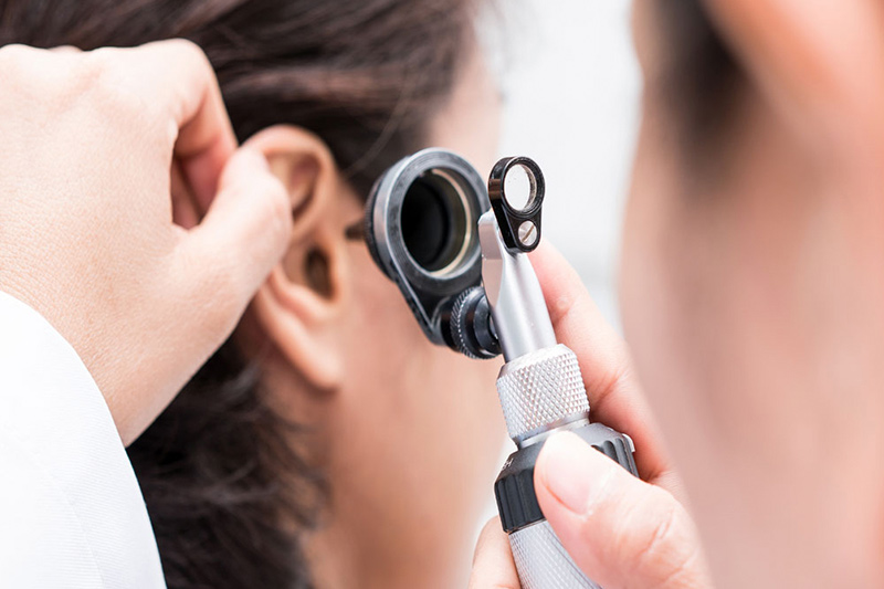 This is a stock image of a doctor looking in a patients ears